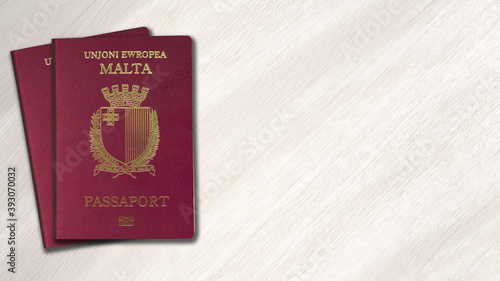 Malta passport on a wooden background, space for texts