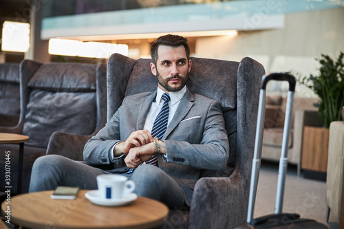 Business professional is winding up his watch