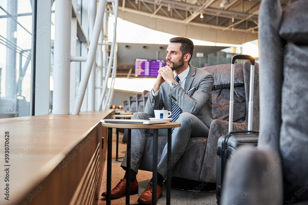 Business executive contemplating something while looking at the window Business executive contemplating something while looking at the window