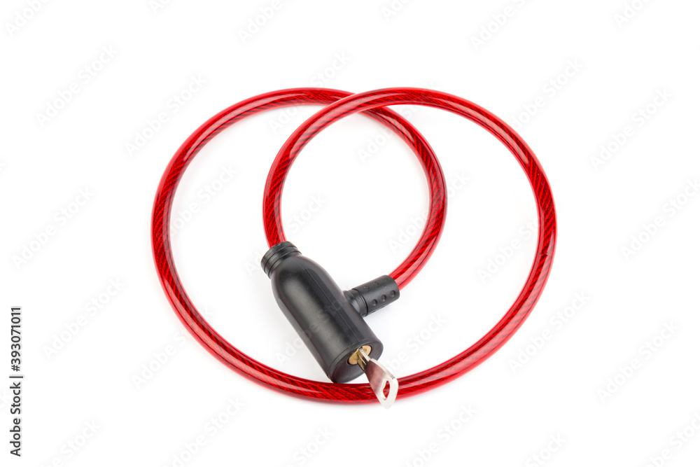 Flexible red bicycle cable with key on white background. Security and safety concept. Flexible red bicycle cable with key on white background. Security and safety concept.