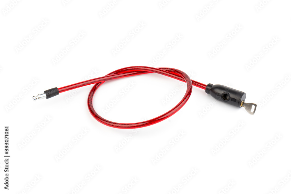 Flexible red bicycle cable with key on white background. Security and safety concept. Flexible red bicycle cable with key on white background. Security and safety concept.