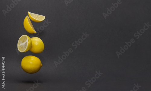 flying lemons on a dark gray background. levitation of objects. trendy background