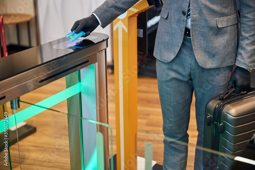 Business official coming through a swing turnstile gate photo