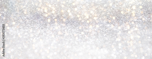 Festive silver glitter background with bokeh lights