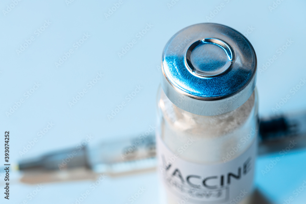 Vial of vaccine bottle with a syringe close up Vial of vaccine bottle with a syringe close up