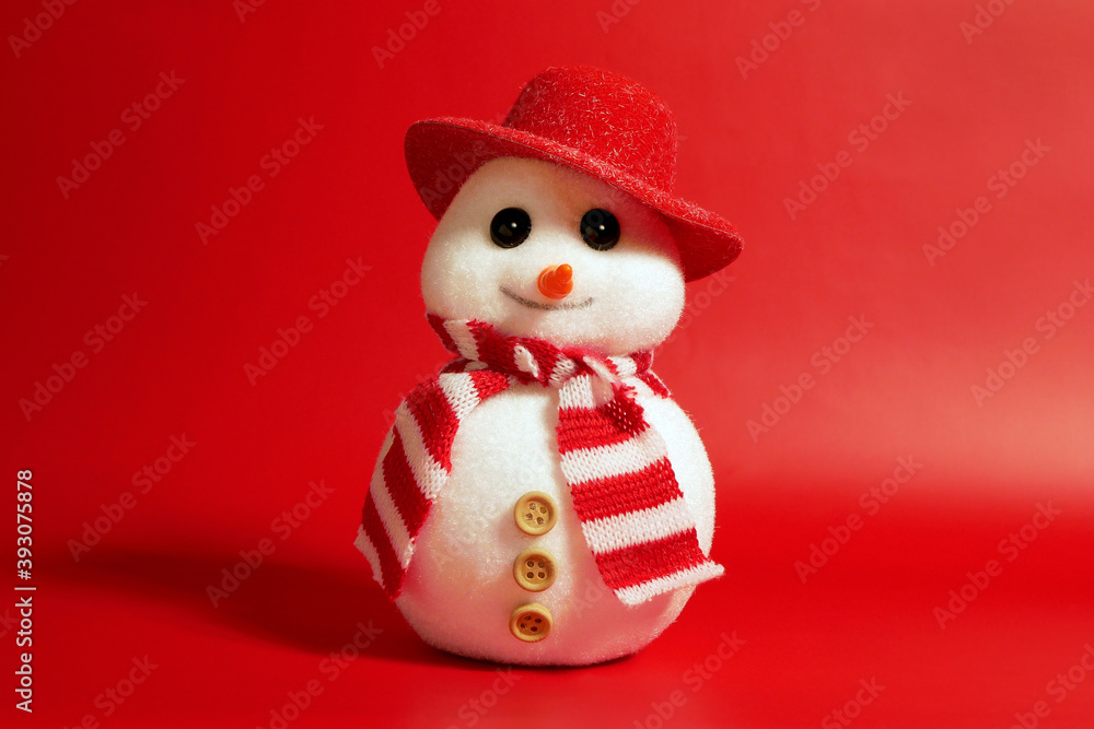 Handsome snowman in hat and scarf on red background, Christamas concept.