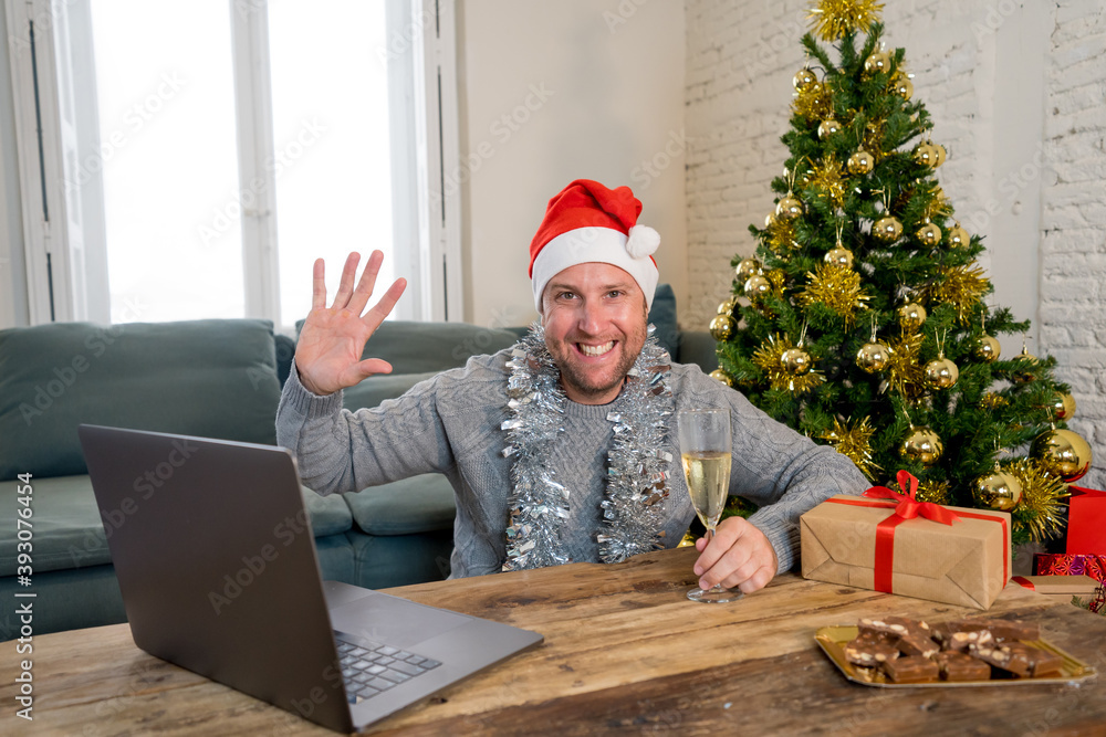 Happy man on video call celebrating virtual christmas with family online at home in lockdown Happy man on video call celebrating virtual christmas with family online at home in lockdown