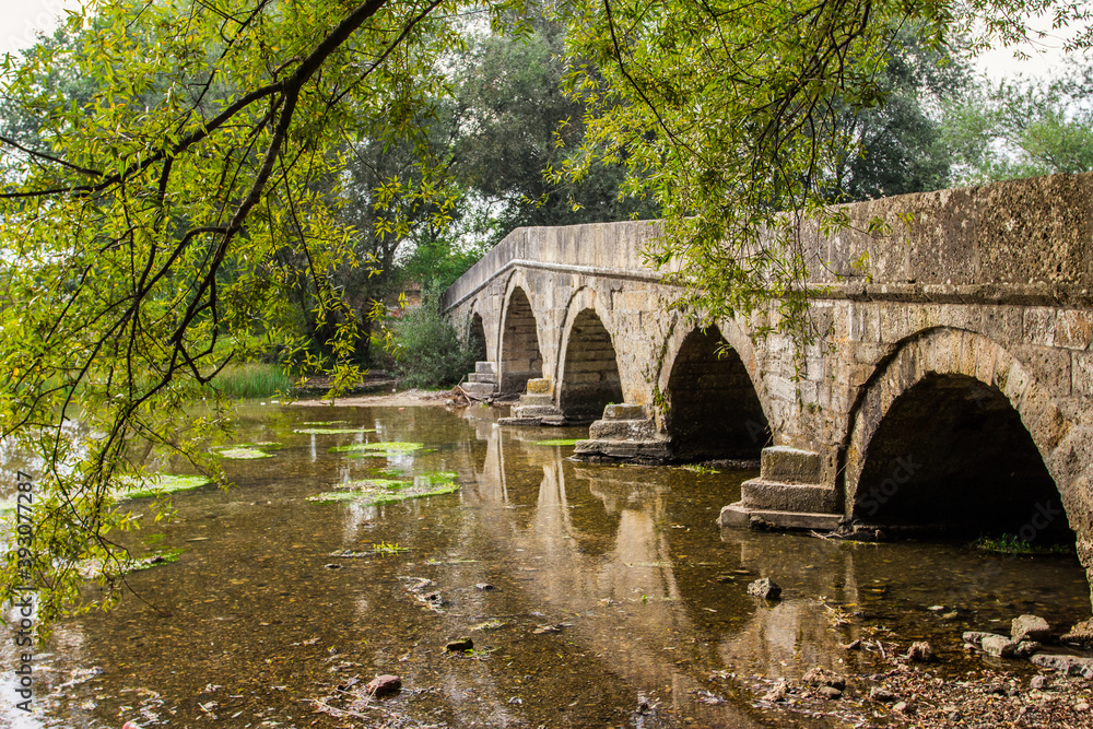 Historic stone Roman bridge in Vrelo Bosne Park near Sarajevo. Bosnia and Herzegovina