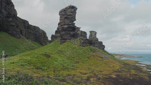 Two Brothers rocks on the shore of the Barents sea on the Sredny Peninsula. Murmansk region, Russia. photo