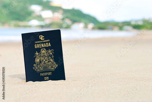 Foto Grenada passport on the beach sand ,Space for writing