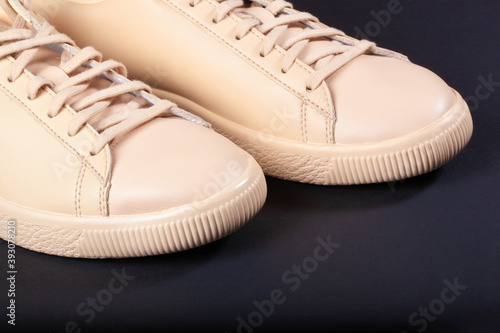 Close-up shot of beige beige sneakers with beige laces