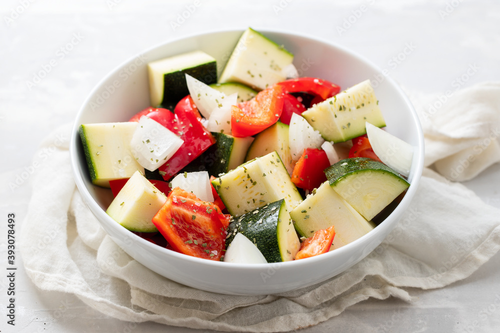 fresh vegetables in cubes in the white bowl