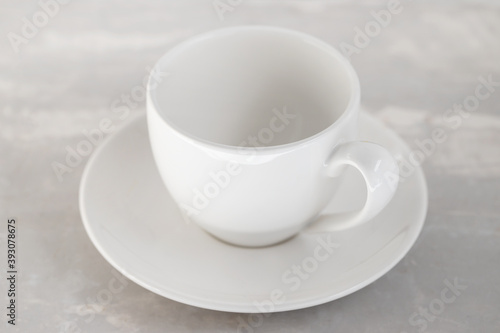 white empty cup on ceramic background