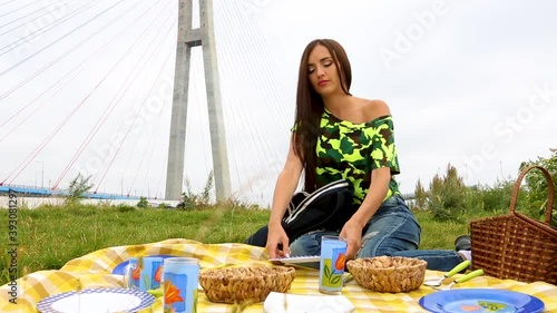 girl lays out dishes at a picnic