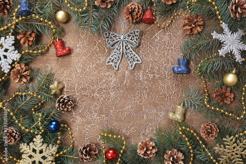 Christmas decorations, branches with cones, toys, on a brown background. With space for text. New year background.