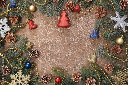 Christmas decorations, branches with cones, toys, on a brown background. With space for text. New year background.