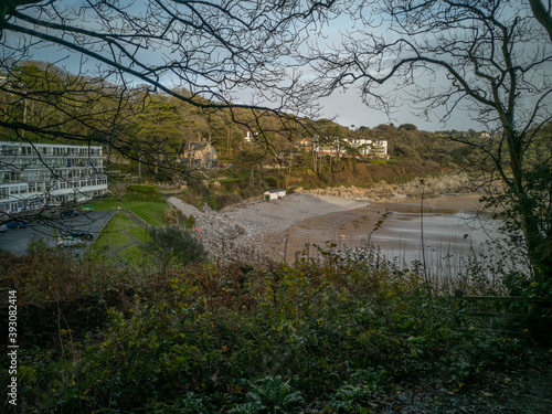 Looking down on Caswell Bay Beach from the Gower Coastal Path in late Autumn. Trees without leaves and rich colours. photo