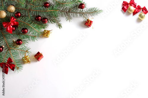 White Christmas background with Christmas tree branches and red balls, baws, giftboxes, winter festive composition with copy space