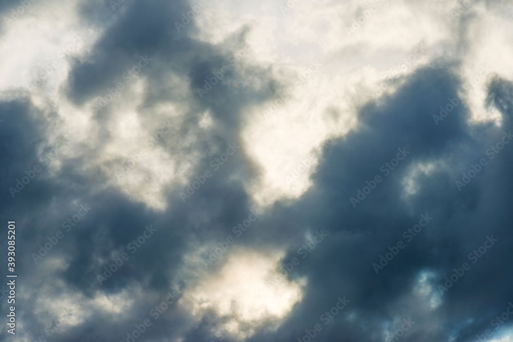 Fototapeta premium Grey white clouds in a blue sky in bright sunlight in autumn, Almere, Flevoland, The Netherlands, November 16, 2020