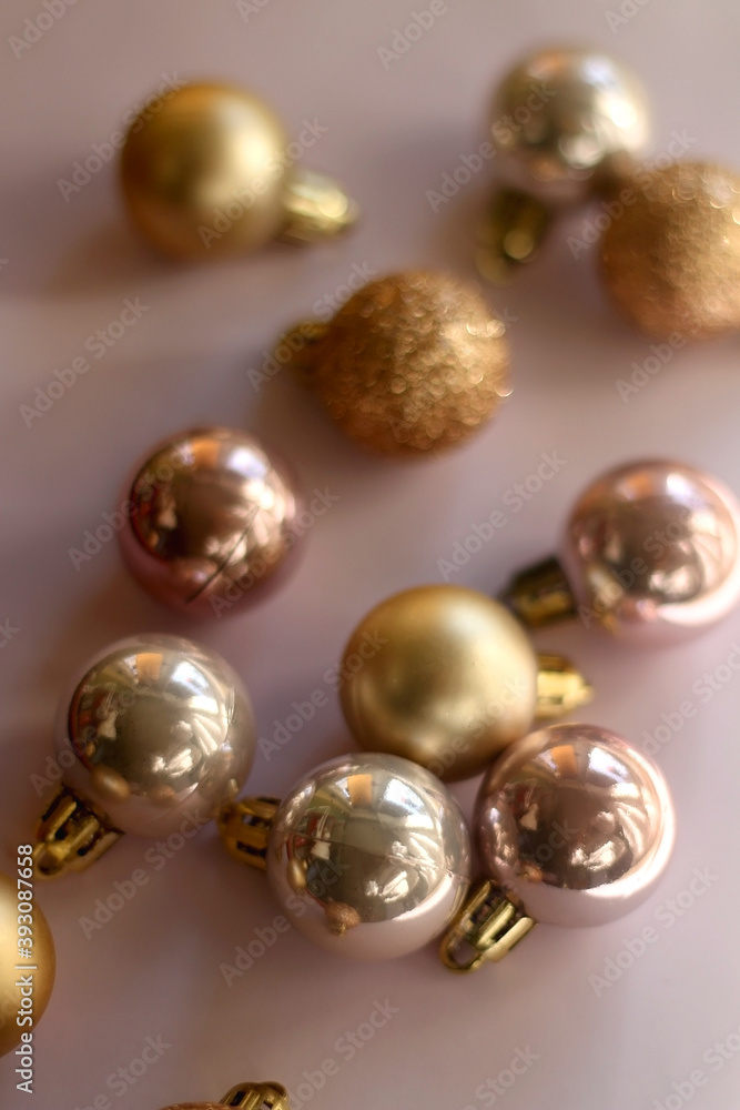 Christmas baubles in gold and pink tones. Selective focus, pink background. Christmas baubles in gold and pink tones. Selective focus, pink background.