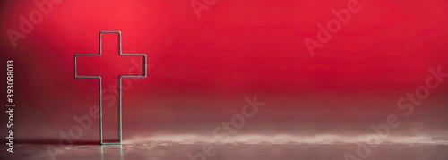 Christian cross on red background with soft bokeh lights background. Copy space. Banner. Church worship, salvation concept. Faith symbol in Jesus Christ. Holy cross for good friday, Easter day