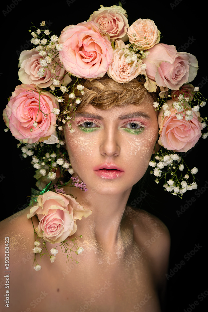 Obraz premium portrait of a beautiful girl with skillful makeup and hair decorated with live roses