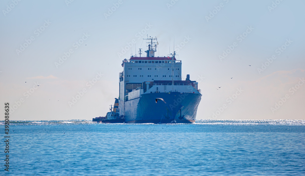 Tugboat assisting cargo ship at Mersin port - Mersin, Turkey 