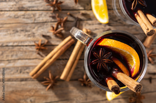 Traditional mulled wine with spices on wooden table. Top view. Copy space