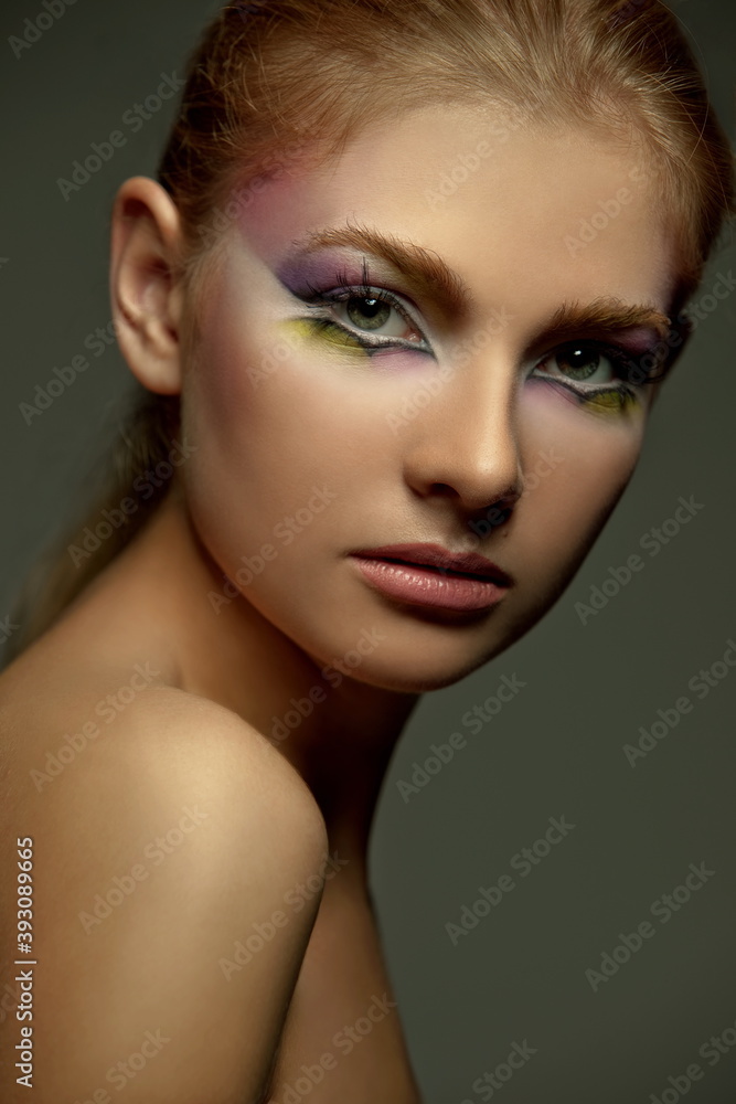 portrait of a beautiful girl with skillful makeup on a dark background portrait of a beautiful girl with skillful makeup on a dark background