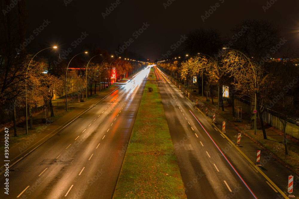 Light trails from cars on a street at night, a street at night in Berlin, Adlergestell in Berlin, Germany