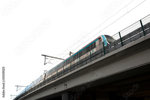 Train passing through overpass standing on isolated white background