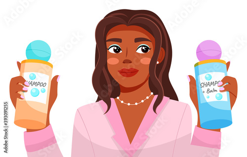 Dark-skinned young beautiful girl in pink jacket, closeup. Girl holds shampoo and balm. Young female with curly hair. Hair care master class. Blogger, streamer, model, video broadcast. Flat image