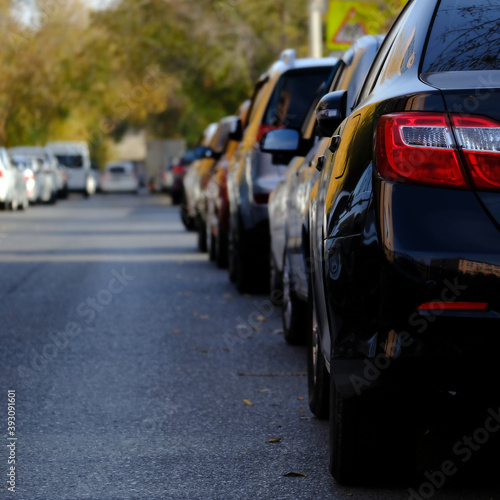 Row of cars parked on the road