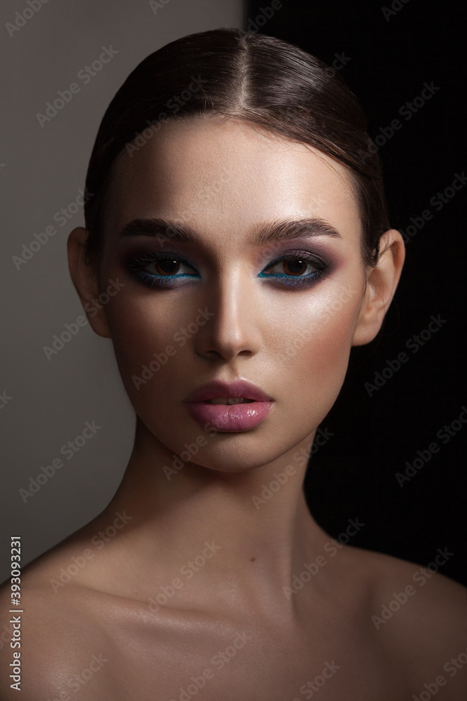 portrait of a beautiful girl with skillful makeup on a dark background portrait of a beautiful girl with skillful makeup on a dark background