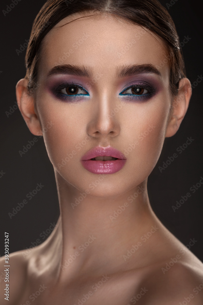 portrait of a beautiful girl with skillful makeup on a dark background portrait of a beautiful girl with skillful makeup on a dark background