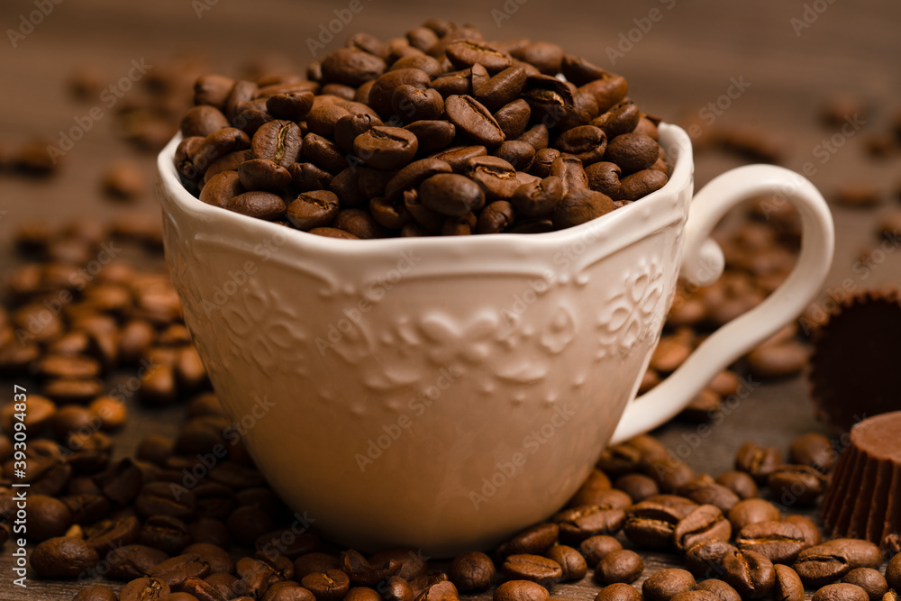 Coffee grains in a porcelain cup Coffee grains in a porcelain cup