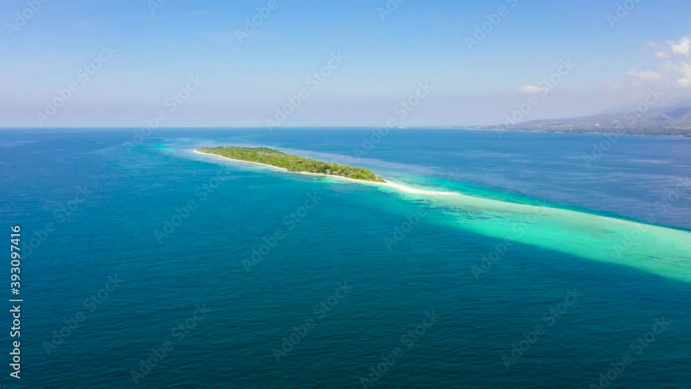 Island with a sandy beach and azure water surrounded by a coral reef and an atoll. Little Santa Cruz island. Zamboanga, Mindanao, Philippines. Island with a sandy beach and azure water surrounded by a coral reef and an atoll. Little Santa Cruz island. Zamboanga, Mindanao, Philippines.