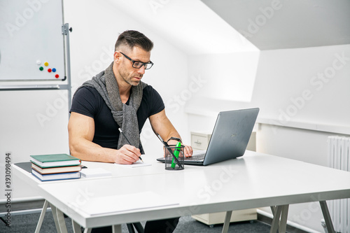 male teacher psychologist coach, in a beautiful office, coworking, attractive, coffee break, in a suit, remote work, business consultant, in glasses.