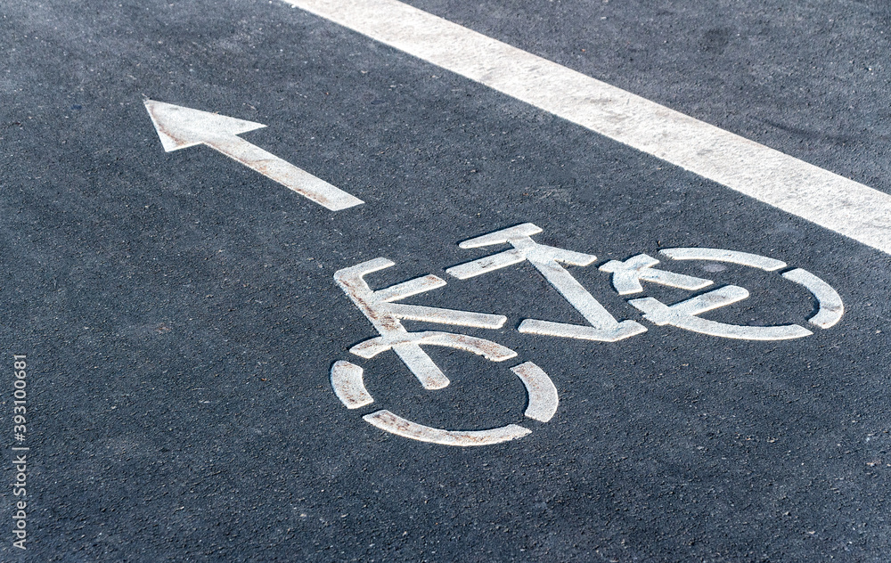 Fototapeta premium Bicycle symbol on a bike lane with directional arrow