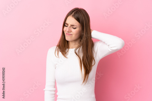 Young woman over isolated pink background with neckache