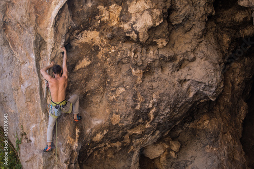 A man trains strength and endurance, rock climbing in Turkey