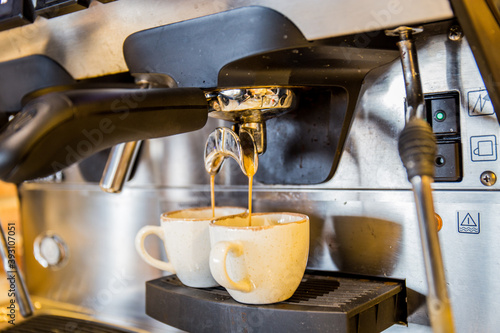 Coffee machine in restaurants and cafes, pouring coffee into cups