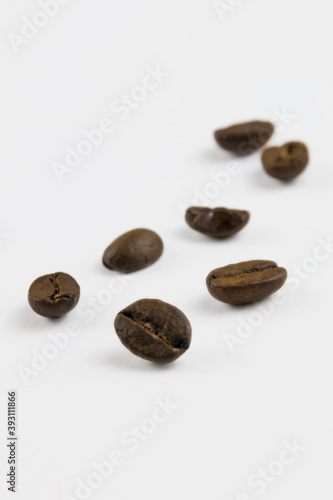 a few isolated coffee beans on a white background  a close-up