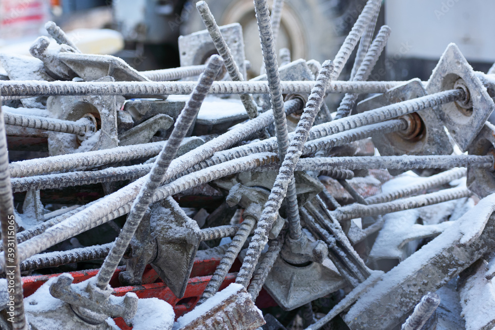 Close-up of metal construction fittings piled up in a pile