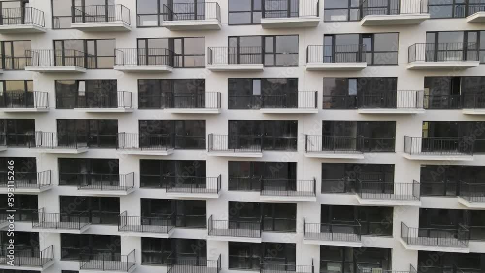 Drone view along the wall of a new apartment building. Drone view along the wall of a new apartment building.