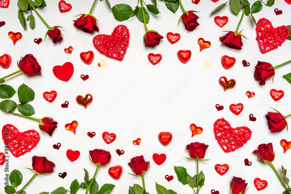Frame made of fresh red roses flowers, hearts and sweets on white background. Beautiful arrangement, greeting card. Love, romance or Valentine's day concept. Flat lay, top view, copy space, mock up Frame made of fresh red roses flowers, hearts and sweets on white background. Beautiful arrangement, greeting card. Love, romance or Valentine's day concept. Flat lay, top view, copy space, mock up
