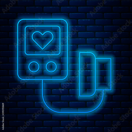 Glowing neon line Blood pressure icon isolated on brick wall background. Vector.