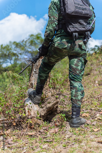 Army soldiers with guns walk patrol.Stay safe in the forest