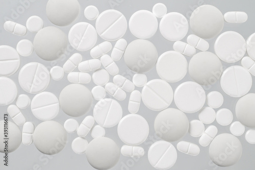 Various white medical pills on white background © natagolubnycha