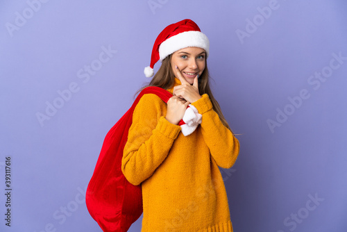 Lithianian woman with christmas hat isolated on purple background happy and smiling